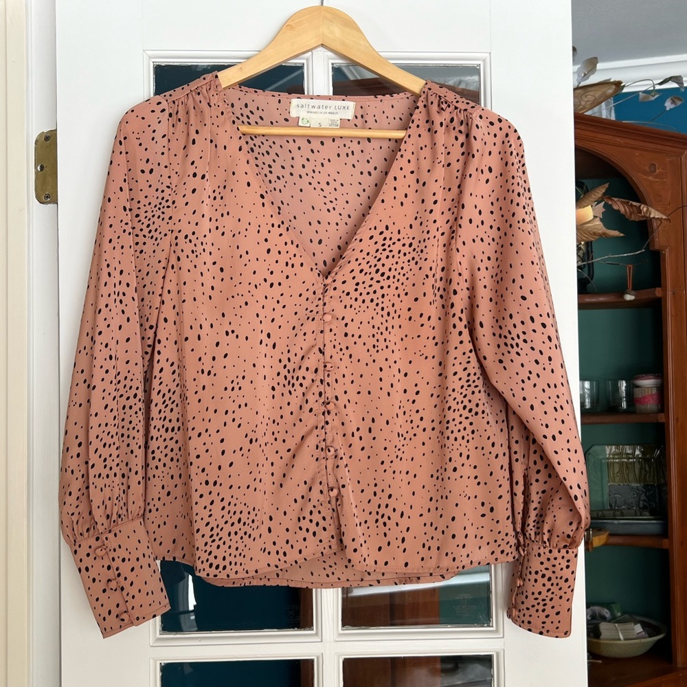Women’s tan with black spots blouse in size small.